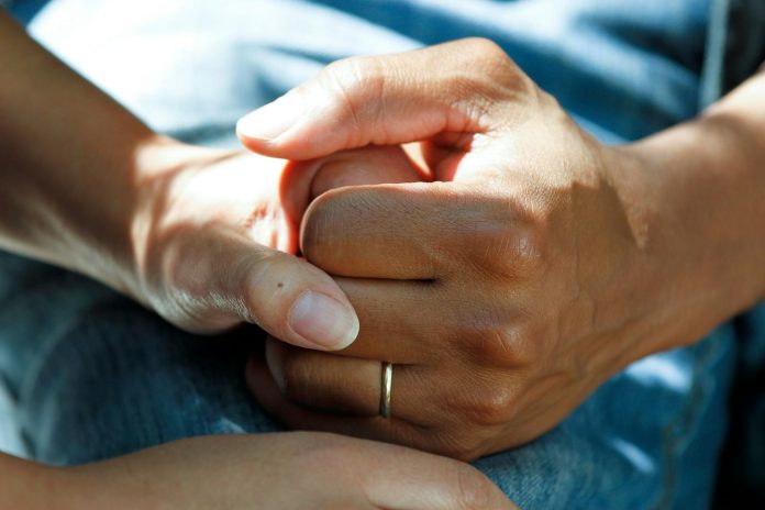 Healthcare professional speaking with an older adult