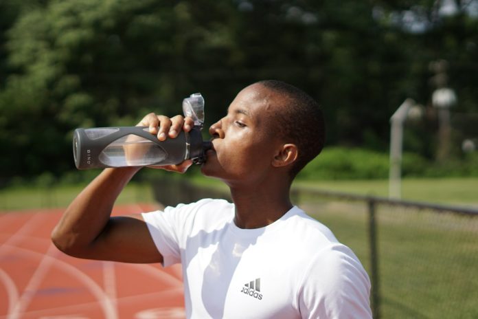 Athlete drinking water during exercise