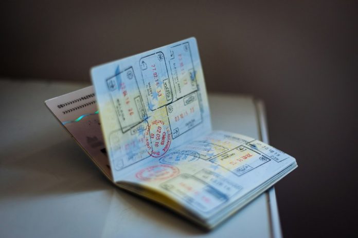 An open passport with travel stamps