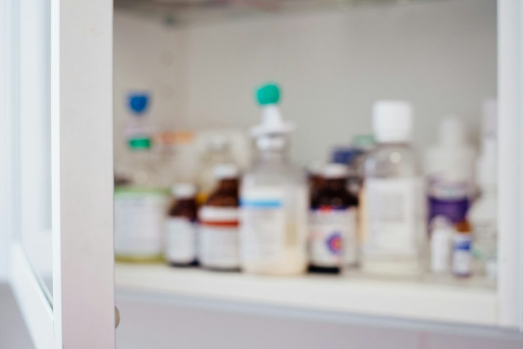 Medicine bottles arranged for a home medicine-cabinet review