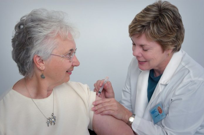 Healthcare professional administering an adult vaccination